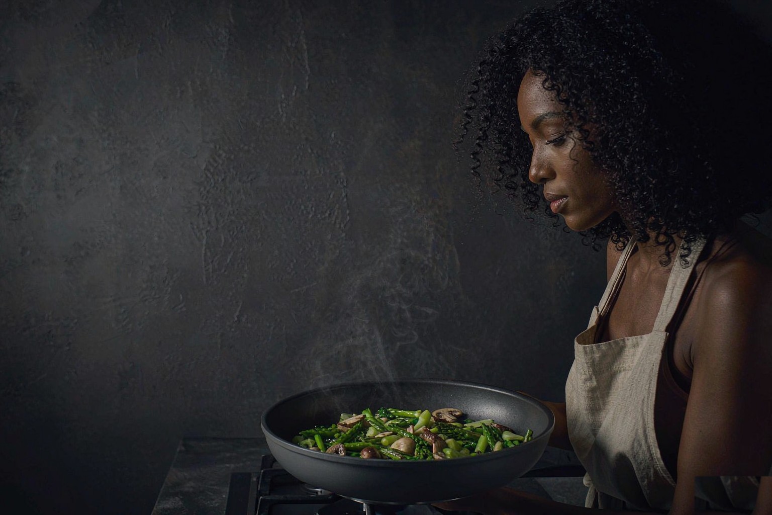 Cook searing vegetables in a Marholm charcoal skillet